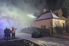 Z hořícího domu v Kroměříži hasiči vynesli dvě osoby. Na místo letěl vrtulník